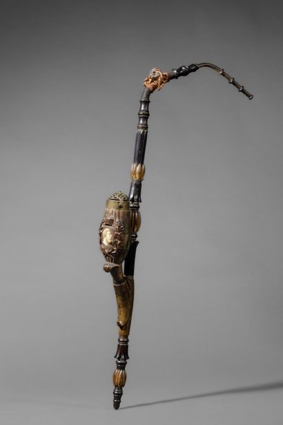 A large wooden and horn pipe with a bowl...
