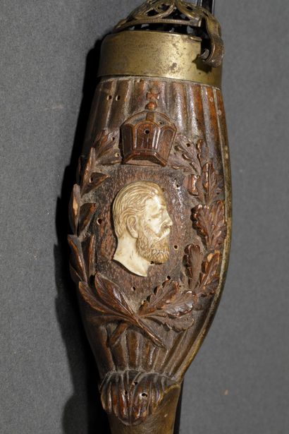 A large wooden and horn pipe with a bowl...