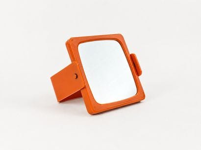 Small double-sided mirror with a magnifying...