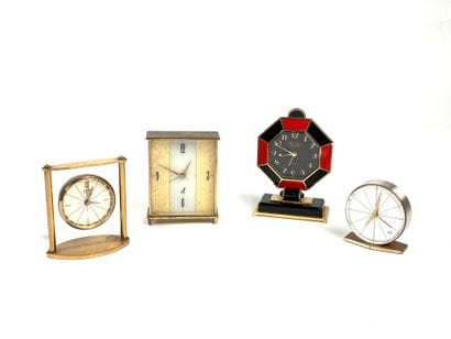 Set of four table clocks including a black-and-red...