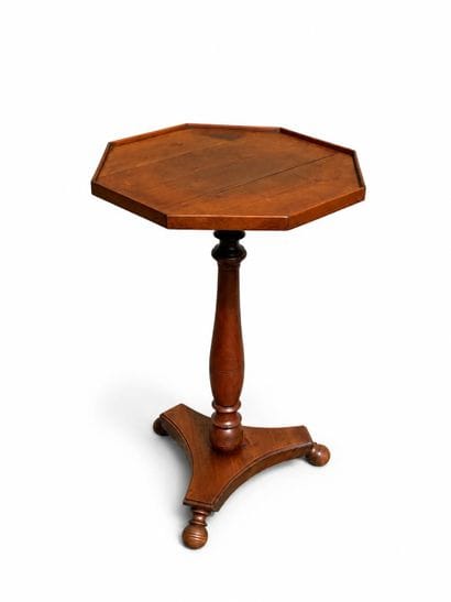 Natural wood side table with a varnished...