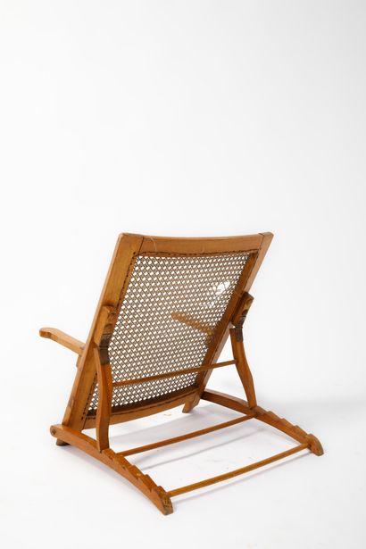 Varnished wood deck chair with cane base
Work...