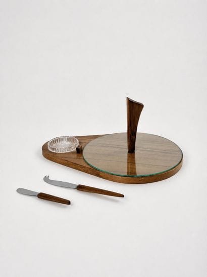 An oblong cheese board made of wood veneer,...