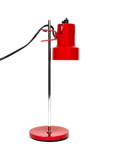 Red-lacquered metal desk lamp on a chrome...