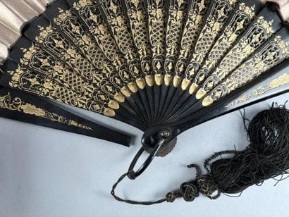 Pink silk fan with a gouache decoration depicting...