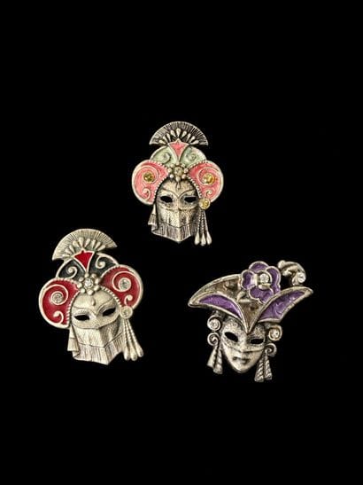 Three brooches shaped like female masks,...