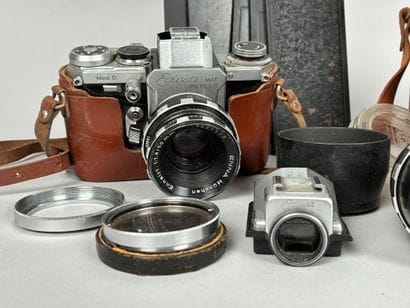 Assorted photography equipment: two cameras...