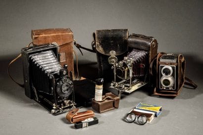 A set of three assorted cameras, including...
