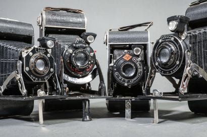 A set of four assorted bellows cameras, including...