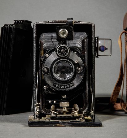 A set of three assorted cameras, including...