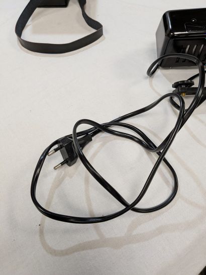Black lacquered metal camera flash, in a...