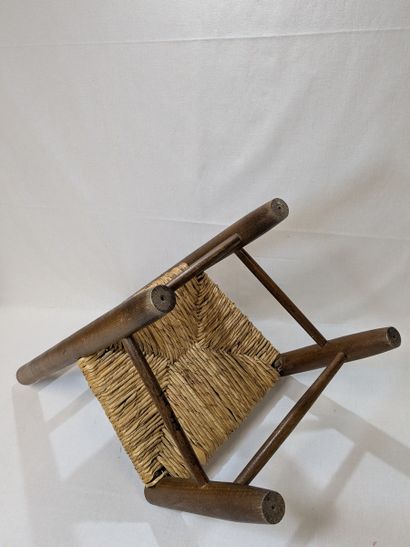 Wooden children's chair with a straw seat....