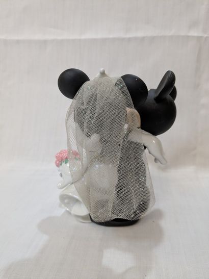 Ceramic figurine featuring Mickey and Minnie,...