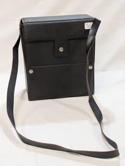 Black lacquered metal camera flash, in a...