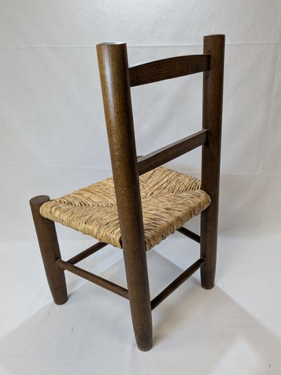 Wooden children's chair with a straw seat....