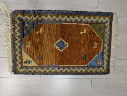 Wool rug with a stylized animal design on...