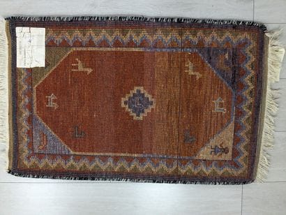 Wool rug with a stylized animal design on...