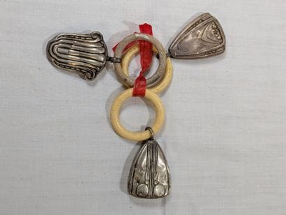 Lot de trois hochets en argent et résine....