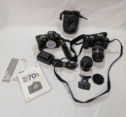 NIKON. Set of two cameras—one D70s and one...