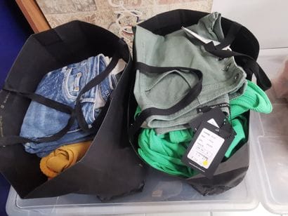 Fort lot de vêtements dans une caisse et...