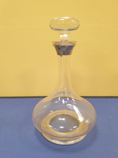 A decanter adorned with a bunch of grapes...
