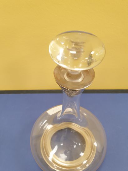 A decanter adorned with a bunch of grapes...