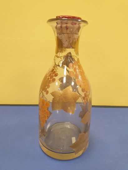 A decanter decorated with vine motifs
With...