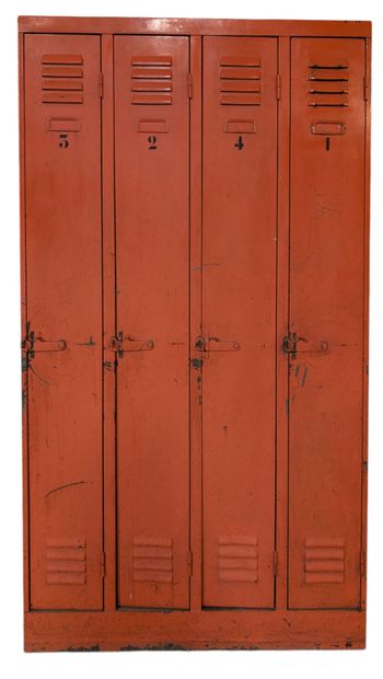 Orange-lacquered metal wardrobe opening with...