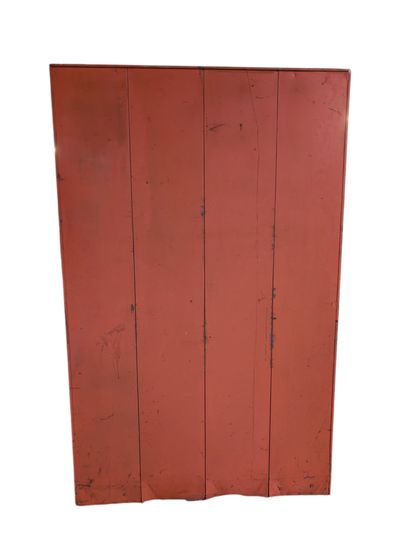Orange-lacquered metal wardrobe opening with...