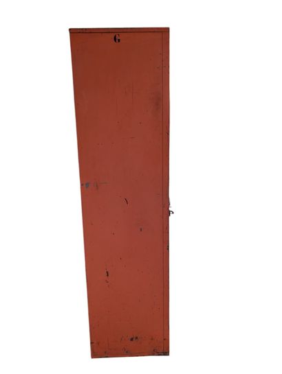Orange-lacquered metal wardrobe opening with...