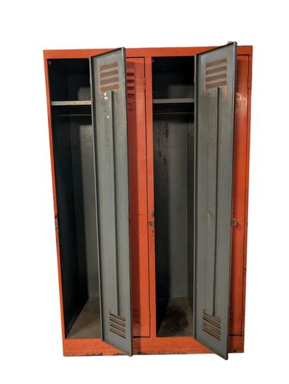 Orange-lacquered metal wardrobe opening with...