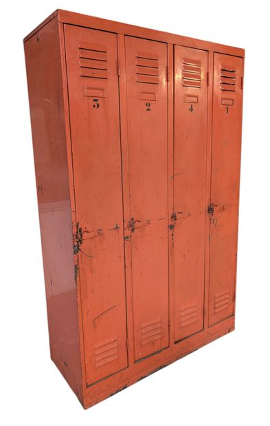 Orange-lacquered metal wardrobe opening with...