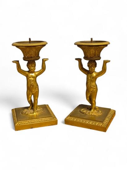 A pair of chased ormolu table candlesticks...
