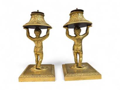 A pair of chased ormolu table candlesticks...