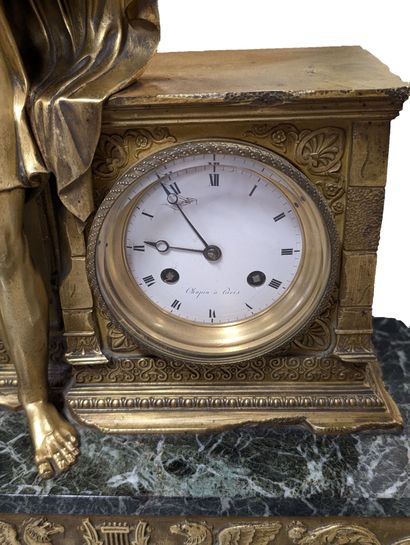 Gilt bronze terminal clock flanked by the...