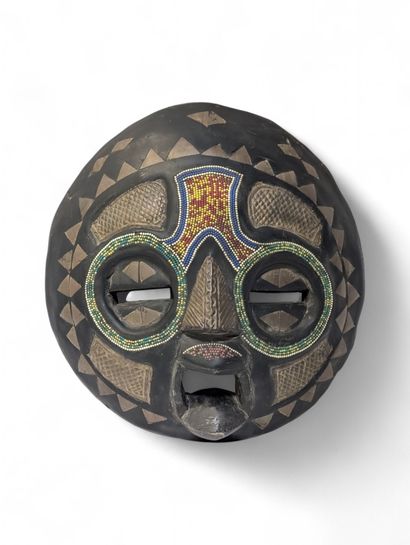 Masque en bois sculpté de forme circulaire...
