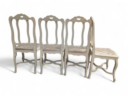 Suite de quatre chaises cannées en bois laqué...
