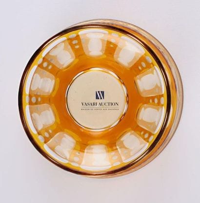 A bohemian ochre crystal bowl, it rests on...