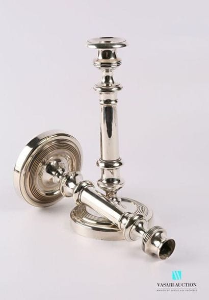 Pair of silver plated metal torches resting...