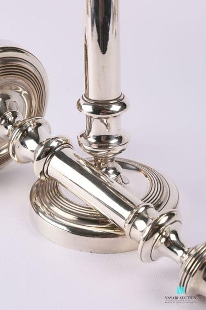 Pair of silver plated metal torches resting...