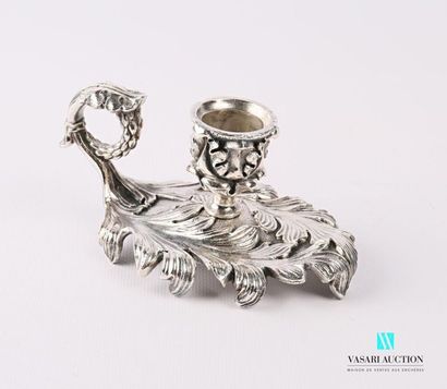 A silver bronze hand candleholder resting...