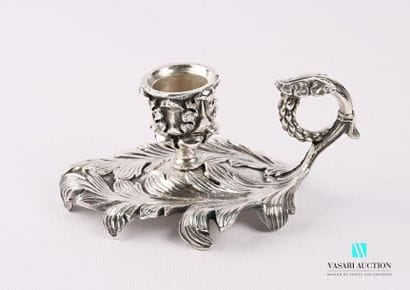 A silver bronze hand candleholder resting...