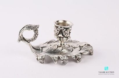 A silver bronze hand candleholder resting...