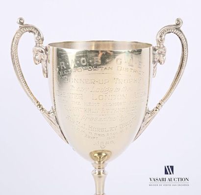 A silver-plated metal bowl resting on a pedestal...