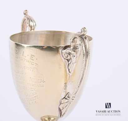 A silver-plated metal bowl resting on a pedestal...