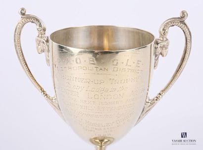 A silver-plated metal bowl resting on a pedestal...