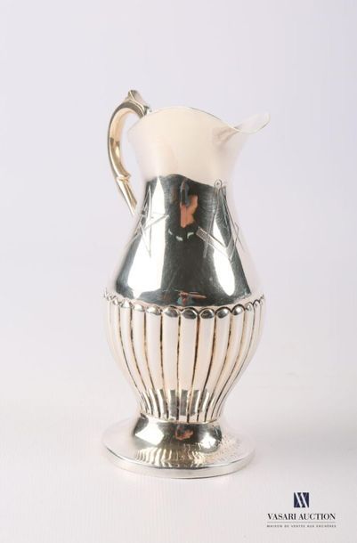 Burette in silver plated metal resting on...
