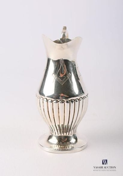 Burette in silver plated metal resting on...