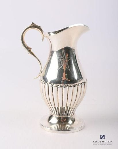 Burette in silver plated metal resting on...