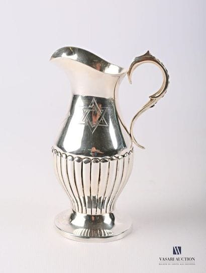 Burette in silver plated metal resting on...